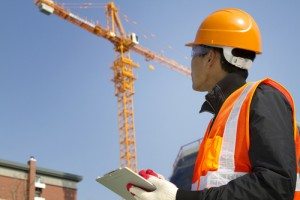 construction worker with crane in background